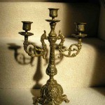 Antiqued brass candelabra on a staircase